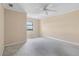 Cozy bedroom with carpet, neutral walls, and a window overlooking city at 795 Hammond Dr # 2101, Atlanta, GA 30328