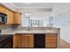 Well-lit kitchen with light wood cabinets and neutral countertops open to living area at 795 Hammond Dr # 2101, Atlanta, GA 30328