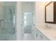Bathroom featuring a glass-door shower with marble-style tiling and a long white counter at 103 Iveybrooke Ln # 56, Alpharetta, GA 30009