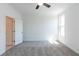 Bright bedroom featuring neutral carpeting, a ceiling fan, and a window letting in natural light at 103 Iveybrooke Ln # 56, Alpharetta, GA 30009