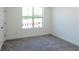 Bedroom featuring a bright window, neutral carpet, and white walls at 103 Iveybrooke Ln # 56, Alpharetta, GA 30009