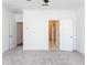 This bedroom includes neutral carpeting, white walls and ceilings, and an open doorway to the bathroom at 103 Iveybrooke Ln # 56, Alpharetta, GA 30009