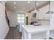Bright kitchen features an island, stainless steel appliances, and hardwood floors at 103 Iveybrooke Ln # 56, Alpharetta, GA 30009