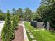 Landscaped backyard featuring a tennis court and privacy fence at 4440 Webb Bridge Rd, Alpharetta, GA 30005
