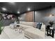 Inviting basement features a sectional sofa, modern lighting, and contemporary decor, ideal for relaxation at 4440 Webb Bridge Rd, Alpharetta, GA 30005