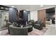 Finished basement with cozy seating, custom cabinets, wine refrigerators, wet bar, and sliding door at 4440 Webb Bridge Rd, Alpharetta, GA 30005
