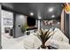 Basement living area with modern decor, large screen TV, and comfortable seating, perfect for movie nights at 4440 Webb Bridge Rd, Alpharetta, GA 30005