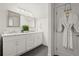 Elegant bathroom featuring double vanity, marble countertop, large mirror, and modern lighting fixtures at 4440 Webb Bridge Rd, Alpharetta, GA 30005
