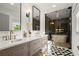 Modern bathroom with double sinks, sleek vanities, and a glass-enclosed shower with a soaking tub at 4440 Webb Bridge Rd, Alpharetta, GA 30005