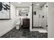 Stylish bathroom with a glass shower, black hexagon tile floor, and modern fixtures at 4440 Webb Bridge Rd, Alpharetta, GA 30005