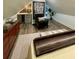 Bedroom space complete with decor, hardwood flooring, wine storage, and accent furniture at 4440 Webb Bridge Rd, Alpharetta, GA 30005