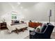 Bright bedroom featuring an upholstered bed, accent chairs, and contemporary decor at 4440 Webb Bridge Rd, Alpharetta, GA 30005