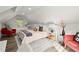 Bright bedroom with vaulted ceilings, hardwood floors, comfortable bed, and pops of red accent chairs at 4440 Webb Bridge Rd, Alpharetta, GA 30005