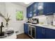 Charming butler's pantry with blue cabinets, wine storage, and elegant countertops at 4440 Webb Bridge Rd, Alpharetta, GA 30005