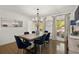 Formal dining room features a stylish light fixture and views of the landscaped yard at 4440 Webb Bridge Rd, Alpharetta, GA 30005