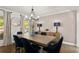 Beautiful dining room showcasing modern decor, hardwood floors, and a large window view at 4440 Webb Bridge Rd, Alpharetta, GA 30005