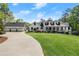 Charming two-story home featuring a three car garage, landscaped yard, and covered front porch at 4440 Webb Bridge Rd, Alpharetta, GA 30005