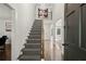 Elegant foyer with hardwood floors, staircase, and open doorway at 4440 Webb Bridge Rd, Alpharetta, GA 30005