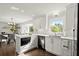 Bright kitchen showcasing white cabinets, stainless appliances, and view to breakfast nook at 4440 Webb Bridge Rd, Alpharetta, GA 30005