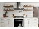 Modern kitchen featuring open shelving, stainless steel appliances, and white subway tile at 4440 Webb Bridge Rd, Alpharetta, GA 30005