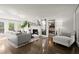 Bright living room with hardwood floors, fireplace, and stylish furniture at 4440 Webb Bridge Rd, Alpharetta, GA 30005