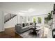 Open living space with modern sofa, fireplace, and outdoor access at 4440 Webb Bridge Rd, Alpharetta, GA 30005