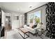 Cozy living room with a white sofa, tufted bench, and decorative curtains at 4440 Webb Bridge Rd, Alpharetta, GA 30005