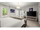 Bright main bedroom with a plush bed, stylish lighting, and a view to the outdoors at 4440 Webb Bridge Rd, Alpharetta, GA 30005