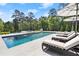 Resort-style pool with integrated spa and luxurious lounging area amidst lush greenery for ultimate relaxation at 4440 Webb Bridge Rd, Alpharetta, GA 30005