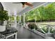 Expansive porch with outdoor seating, plants, and a view of the lush backyard at 4440 Webb Bridge Rd, Alpharetta, GA 30005