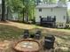 Outdoor space featuring a brick fire pit with seating, a deck, and a view of the home's exterior at 57 Glenn Eagles Way, Hiram, GA 30141