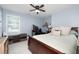 Comfortable bedroom with carpeted floors, a wood-frame bed, and a window at 57 Glenn Eagles Way, Hiram, GA 30141