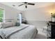 Cozy bedroom featuring carpeted floors, a ceiling fan, and natural light at 57 Glenn Eagles Way, Hiram, GA 30141