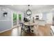Bright dining area with an exit to the deck and view of the kitchen with white cabinetry at 57 Glenn Eagles Way, Hiram, GA 30141