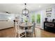 Well-lit dining area with round table, opening to the living room and deck with double doors at 57 Glenn Eagles Way, Hiram, GA 30141
