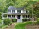 Charming two-story home with a welcoming front porch and well-manicured landscaping at 57 Glenn Eagles Way, Hiram, GA 30141