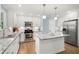 Updated kitchen features stainless appliances, white cabinets and island with granite countertops at 57 Glenn Eagles Way, Hiram, GA 30141