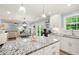 Open-concept kitchen with stainless steel appliances, island and view of the living and dining areas at 57 Glenn Eagles Way, Hiram, GA 30141