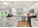 Bright, updated kitchen features a peninsula island with seating, stainless appliances, and modern finishes at 57 Glenn Eagles Way, Hiram, GA 30141
