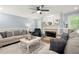 Inviting living room features a fireplace, plush seating, and stylish decor at 57 Glenn Eagles Way, Hiram, GA 30141
