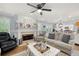 Bright living room with a fireplace and an open view into the kitchen at 57 Glenn Eagles Way, Hiram, GA 30141