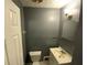 Bathroom featuring a toilet and sink with a single vanity light at 2273 Childress Dr, Atlanta, GA 30311