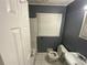 Bathroom featuring a toilet, sink, and bathtub with white tiling at 2273 Childress Dr, Atlanta, GA 30311