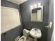 Bathroom featuring a toilet, sink, mirror, and window with blinds at 2273 Childress Dr, Atlanta, GA 30311