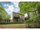 Back exterior of a two-story home featuring a spacious deck and backyard at 2895 Shurburne Dr, Alpharetta, GA 30022