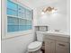 Bright bathroom features a modern vanity, toilet, decorative lighting and a large window at 2895 Shurburne Dr, Alpharetta, GA 30022