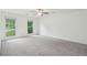 Large primary bedroom featuring neutral carpet, two windows, and ceiling fan at 2895 Shurburne Dr, Alpharetta, GA 30022