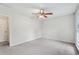 Spacious bedroom with neutral carpet, a ceiling fan, and bright natural light from the windows at 2895 Shurburne Dr, Alpharetta, GA 30022