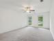 Large carpeted bedroom features a ceiling fan and natural light from the two windows at 2895 Shurburne Dr, Alpharetta, GA 30022