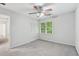 Cozy bedroom with gray carpet, large window, ceiling fan and closet with double doors at 2895 Shurburne Dr, Alpharetta, GA 30022